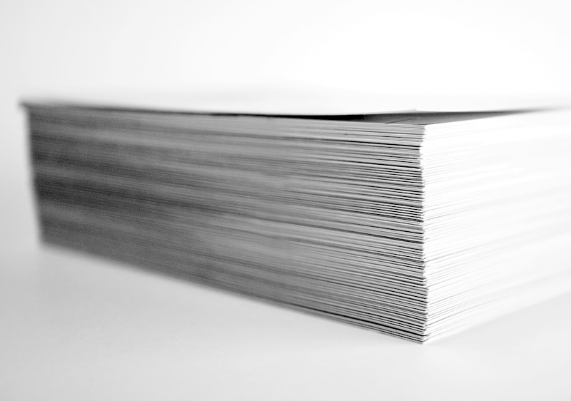 A thick stack of paper documents photographed from the side